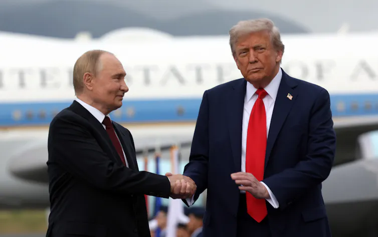 Russian president Vladimir Putin shakes hands with US president Donald Trump in Alaska in August