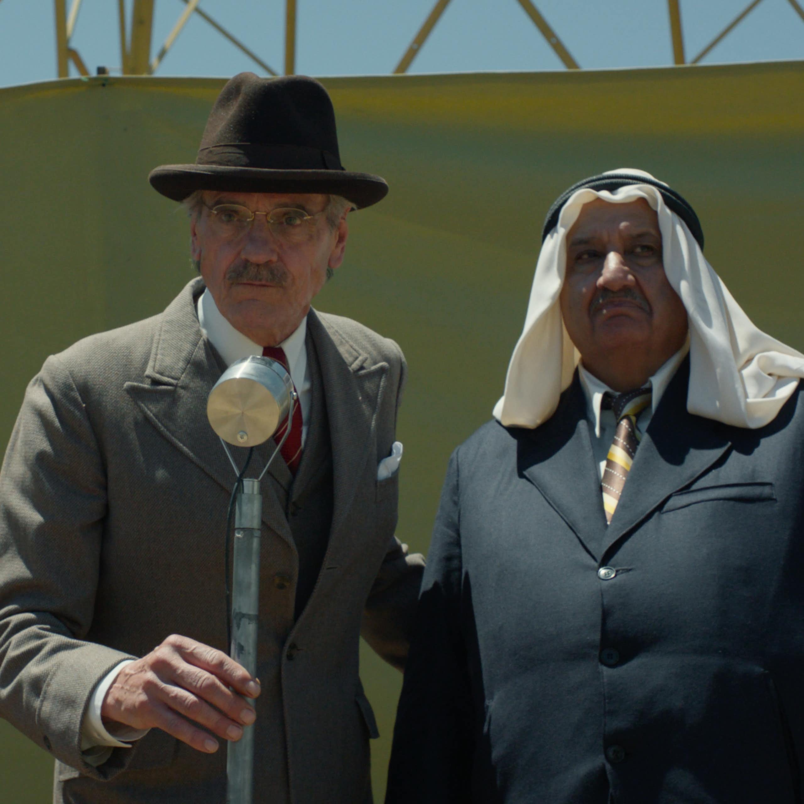 Jeremy Irons in 1930s clothing on a stage