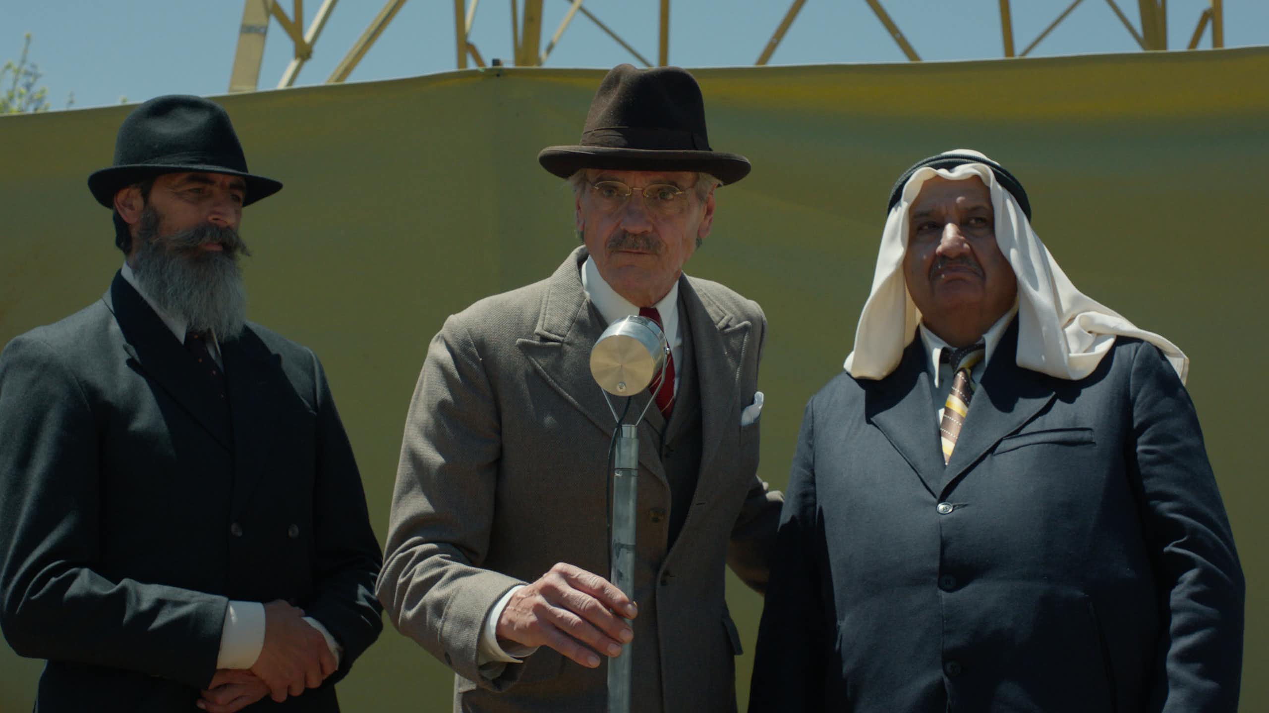 Jeremy Irons in 1930s clothing on a stage