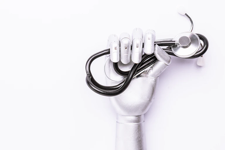 A robot hand holding a stethascope.