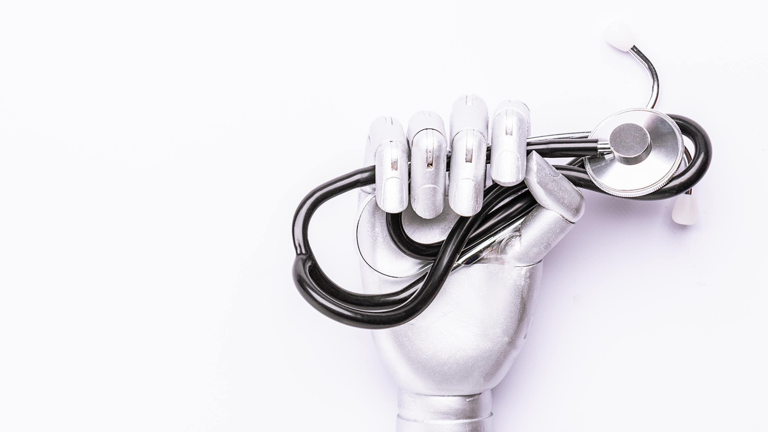 A robot hand holding a stethascope.