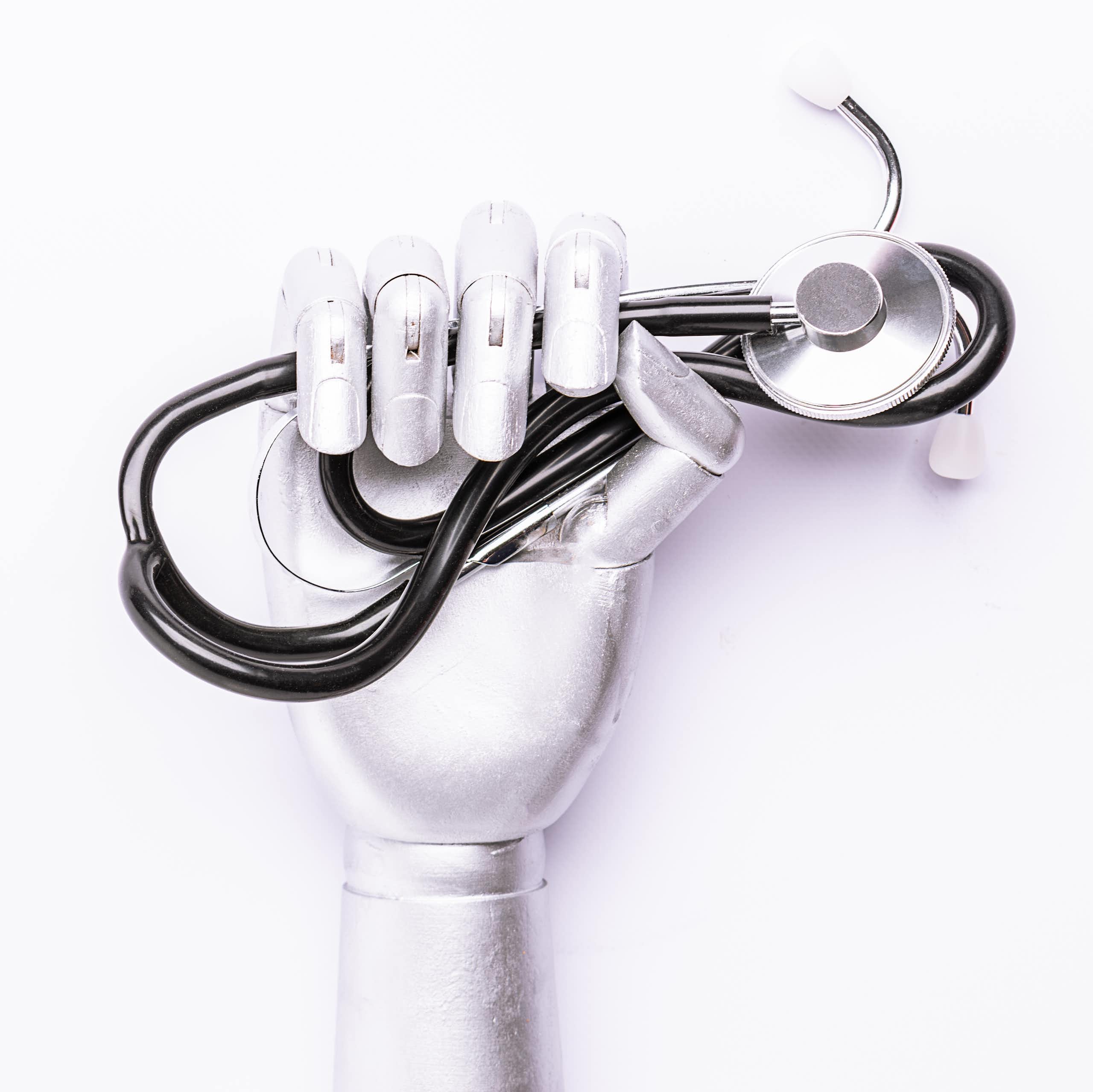 A robot hand holding a stethascope.