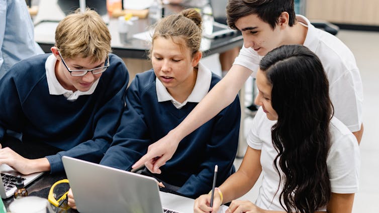 Pupils looking at laptop