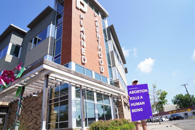 What does ‘pro-life’ imply? There’s no person resolution – even for advocacy teams that oppose abortion 2 A woman holds a sign that says, 'Science says...abortion kills a human being.'