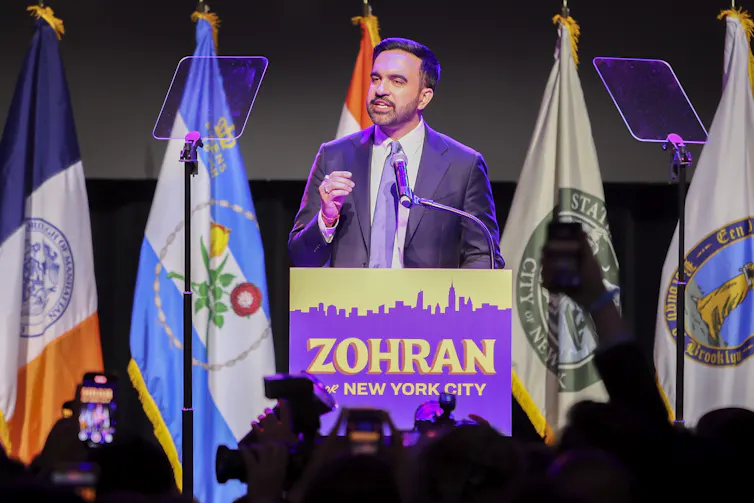 New York mayor Zohran Mamdani speaks at a podium: