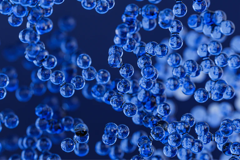 An illustration of small blue spheres clustered together.