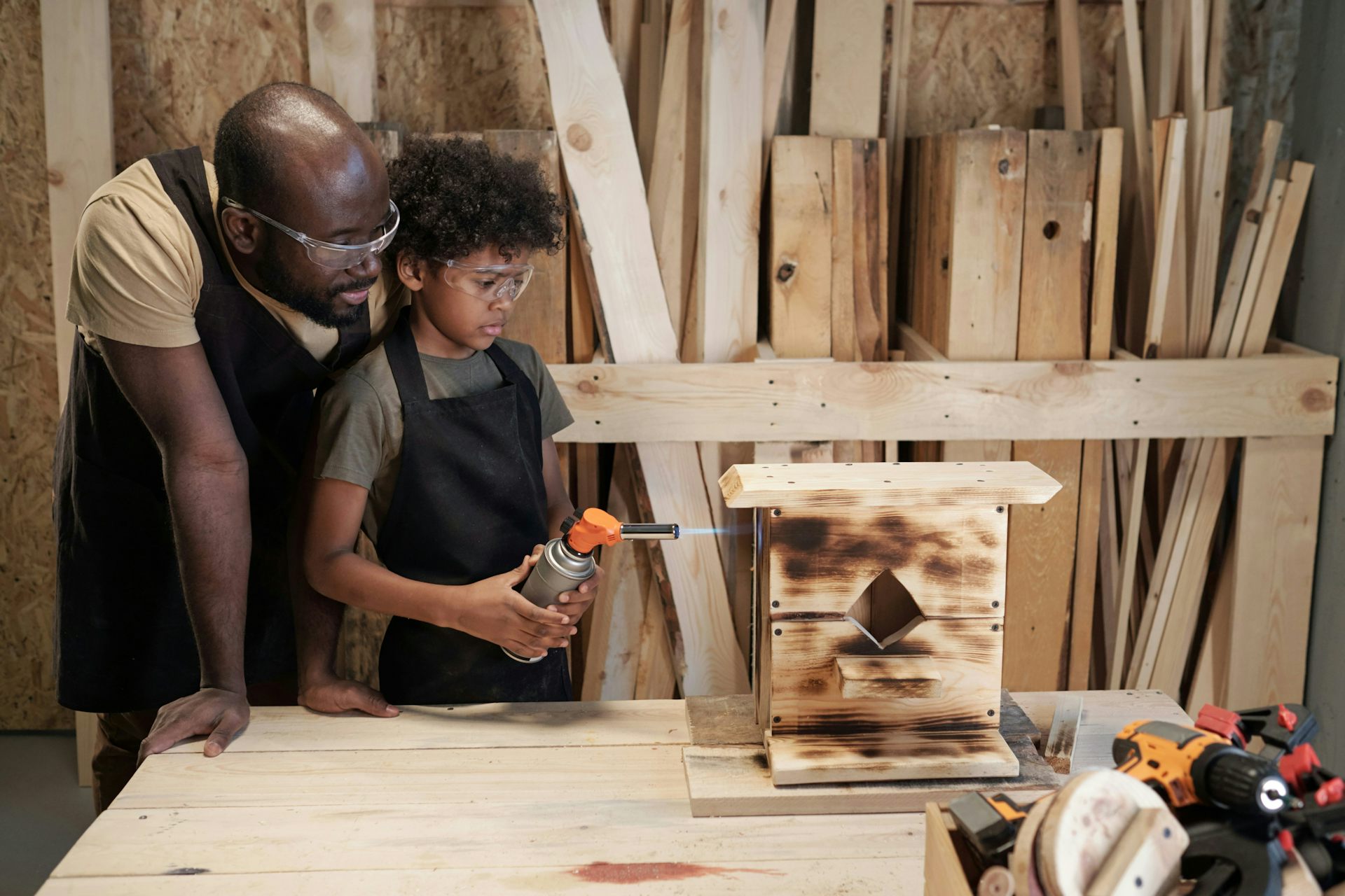 A man shows his son woodworking
