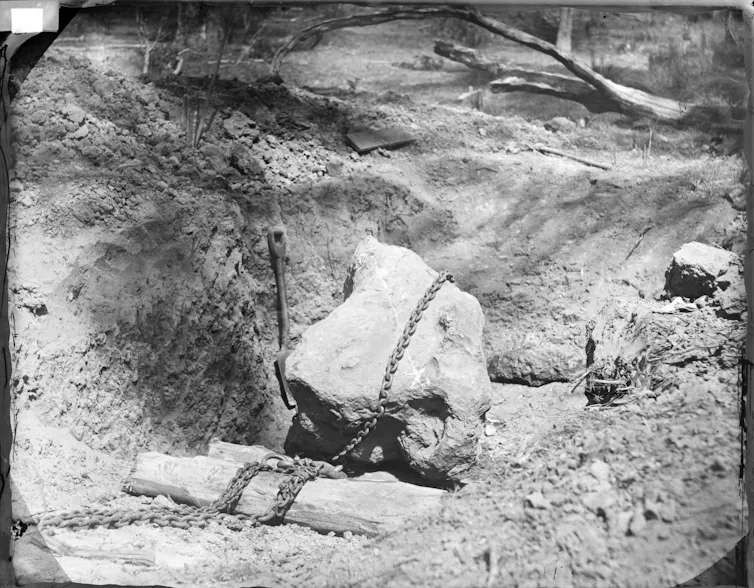 Large meteorite dug out from the surrounding ground with a chain around it