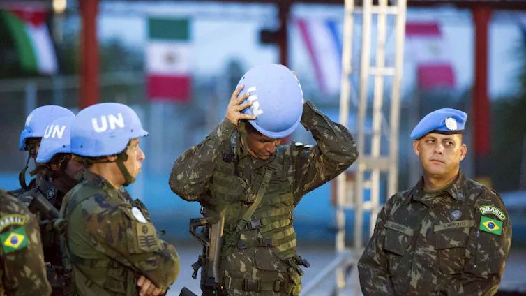 Four soldiers stand together.