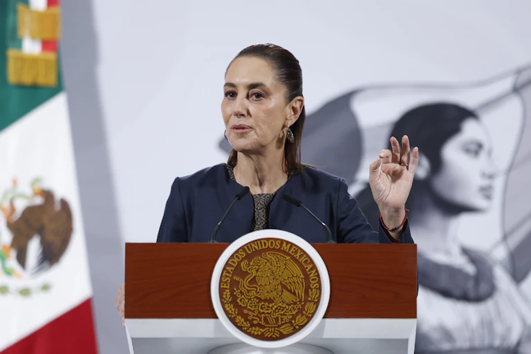 Mexico's president, Claudia Sheinbaum, stands at a podium speaking.