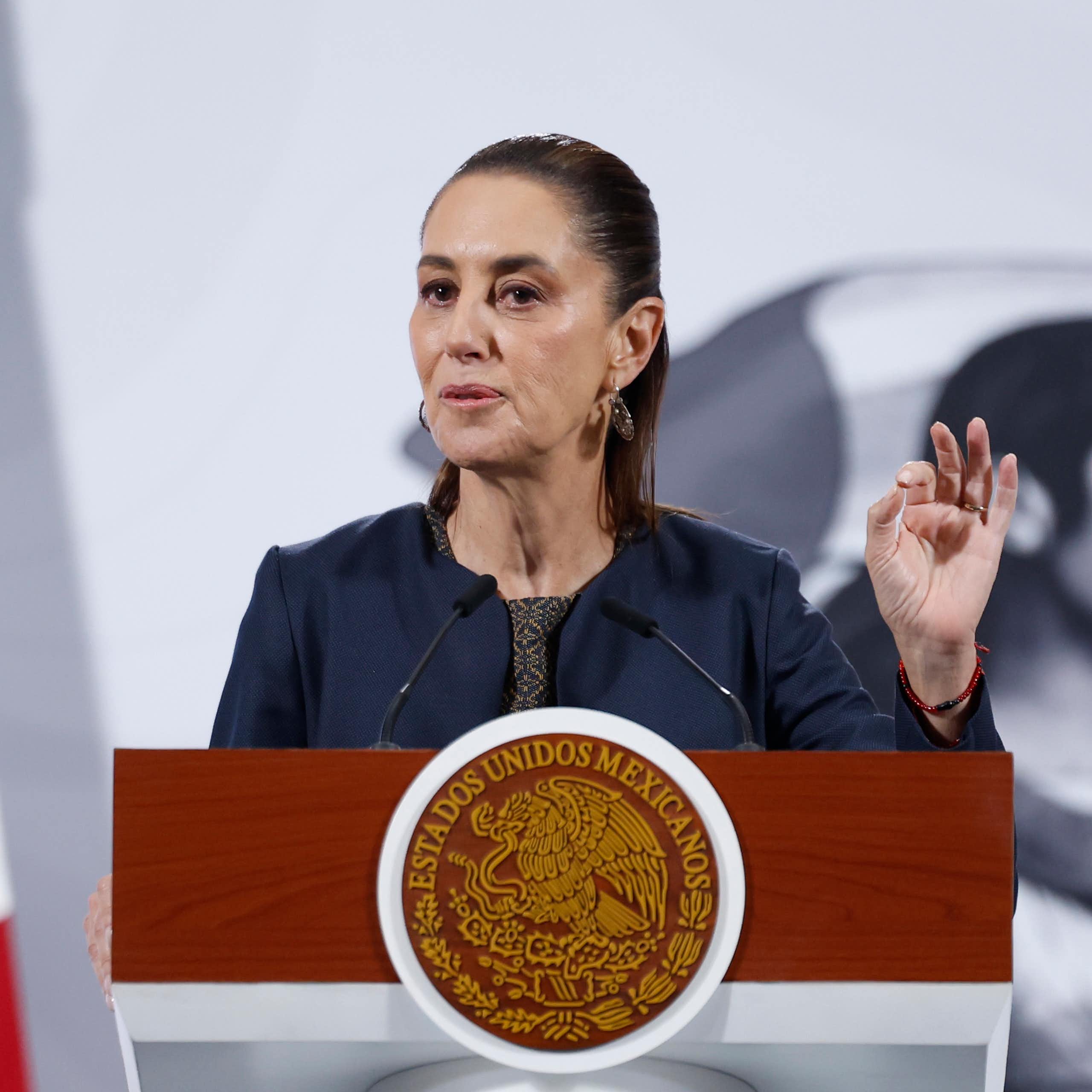Mexico's president, Claudia Sheinbaum, stands at a podium speaking.