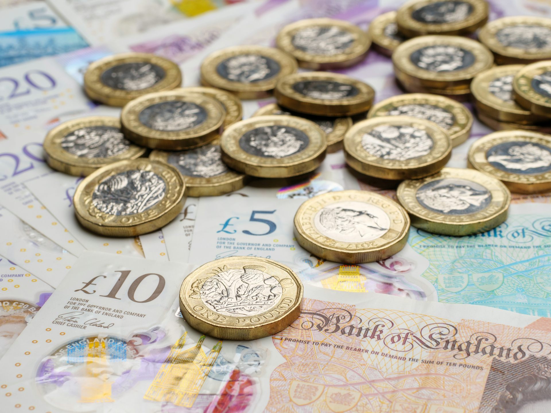 selection of uk banknotes and coins