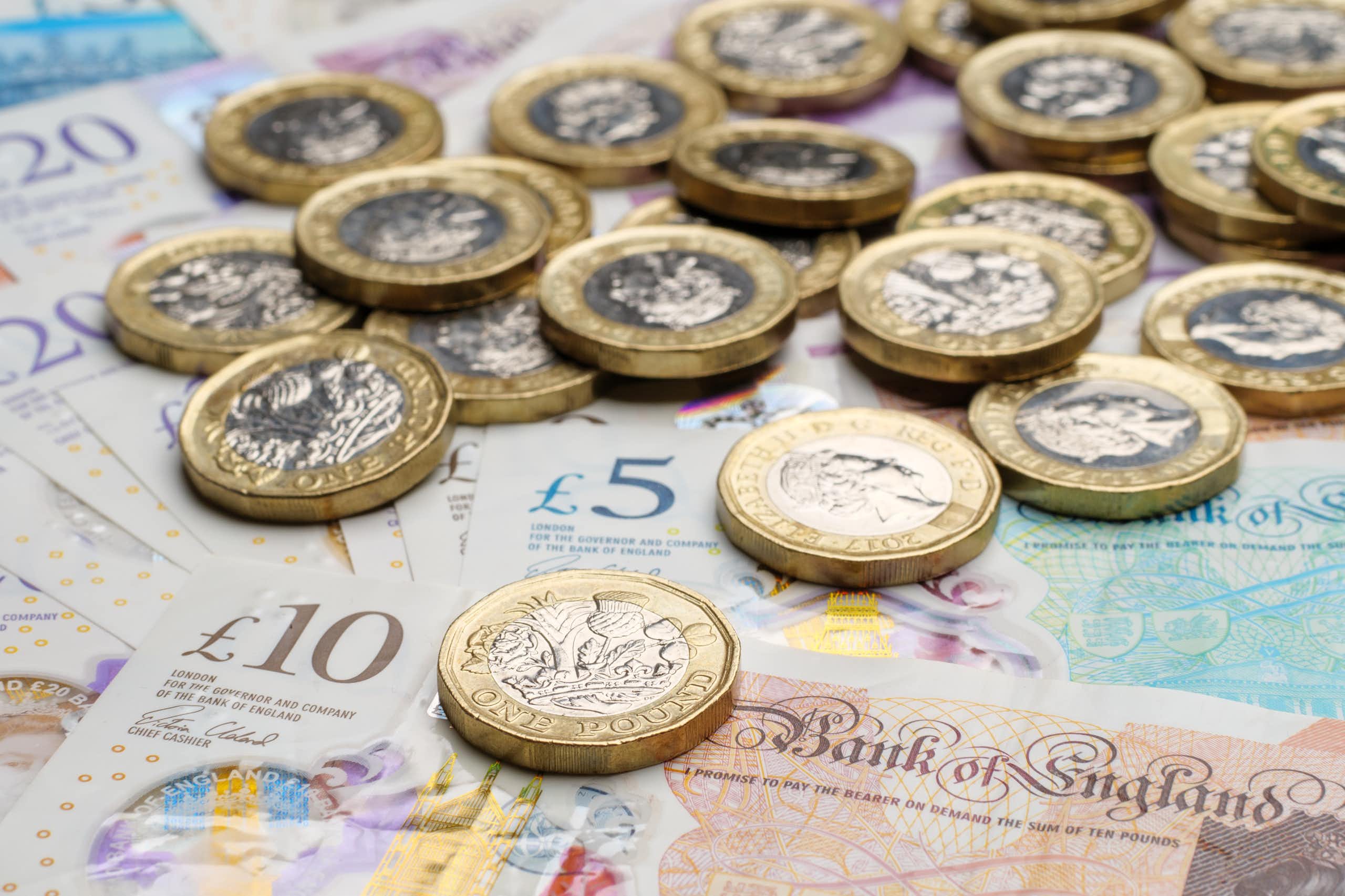 selection of uk banknotes and coins