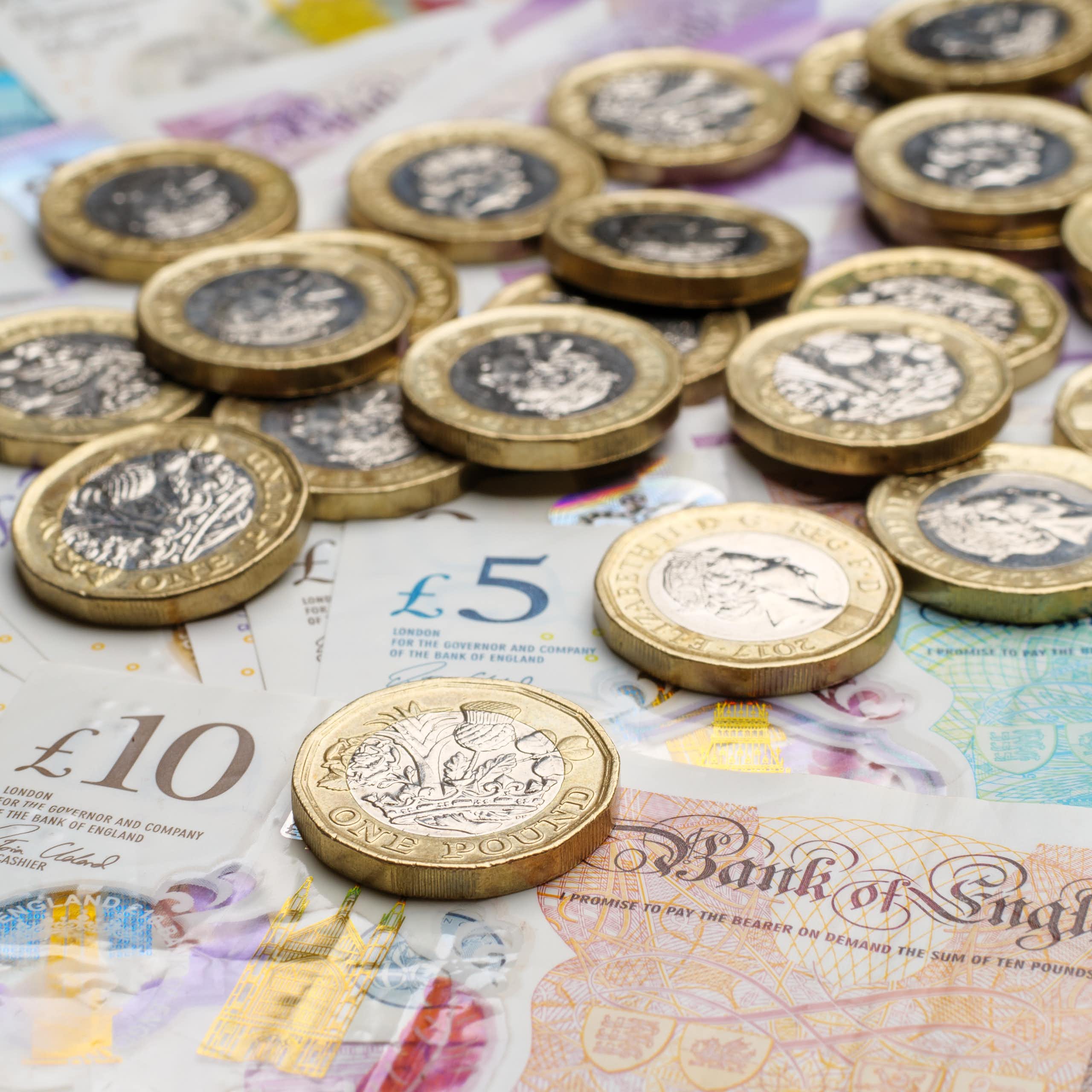 selection of uk banknotes and coins