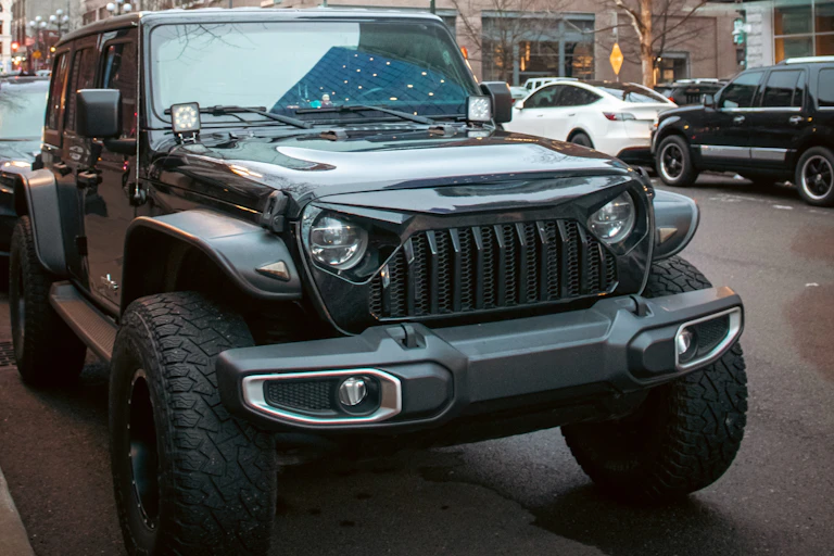 A Jeep parked on a city street.