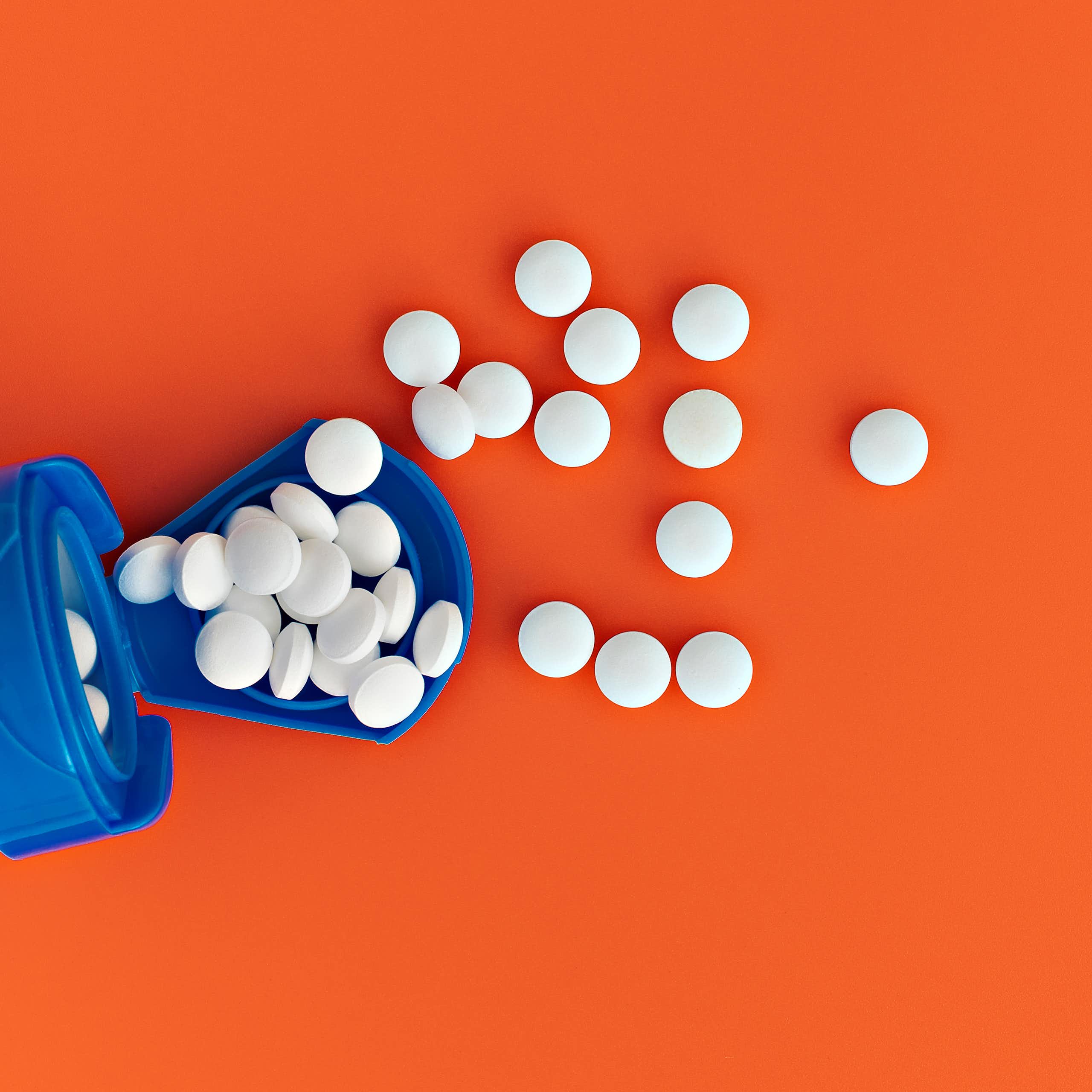 White pills spilling out of a bottle.