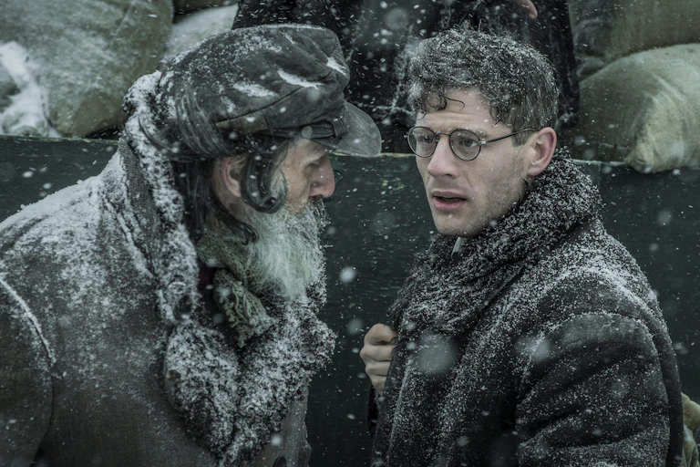 Two men talking in the snow