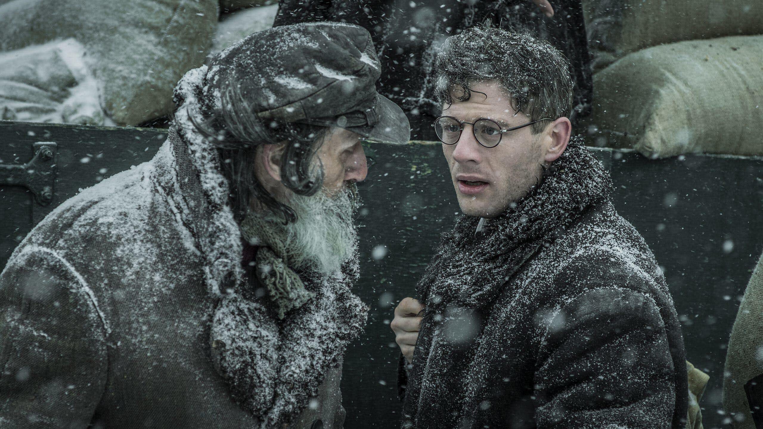 Two men talking in the snow