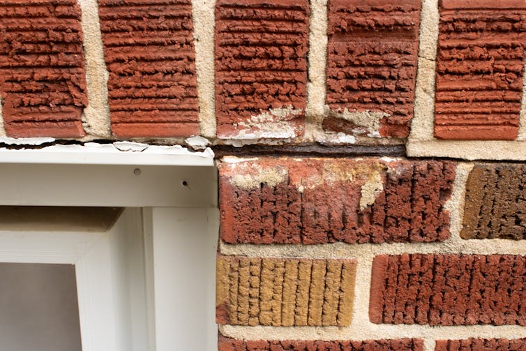 Black households pay extra to stay their homes heat than moderate American households 1 A close-up of brickwork near a window, showing cracks.
