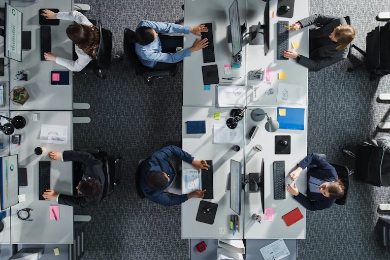 Top Down View of Diverse Colleagues Working In Corporate Office