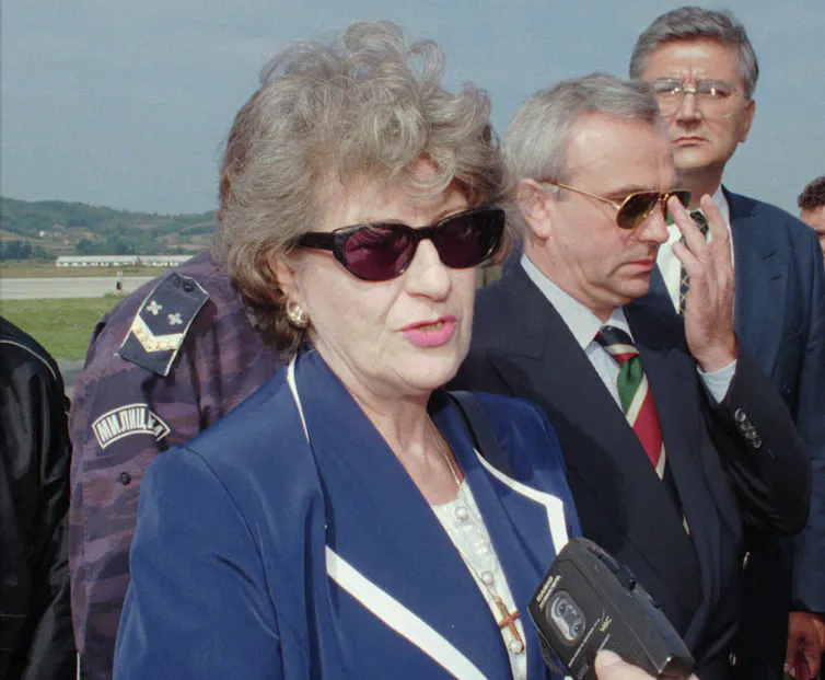Biljana Plavšić in a blue suit and sunglasses.