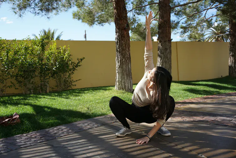 A woman does a deep squat.