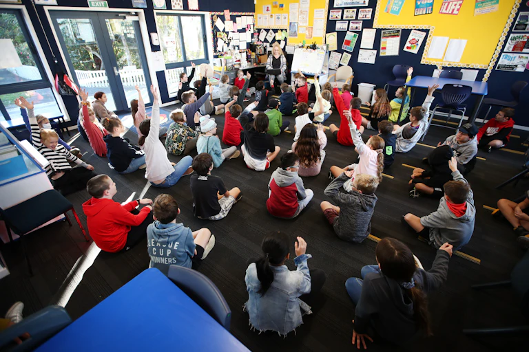 Teacher giving a lesson to a classroom of students