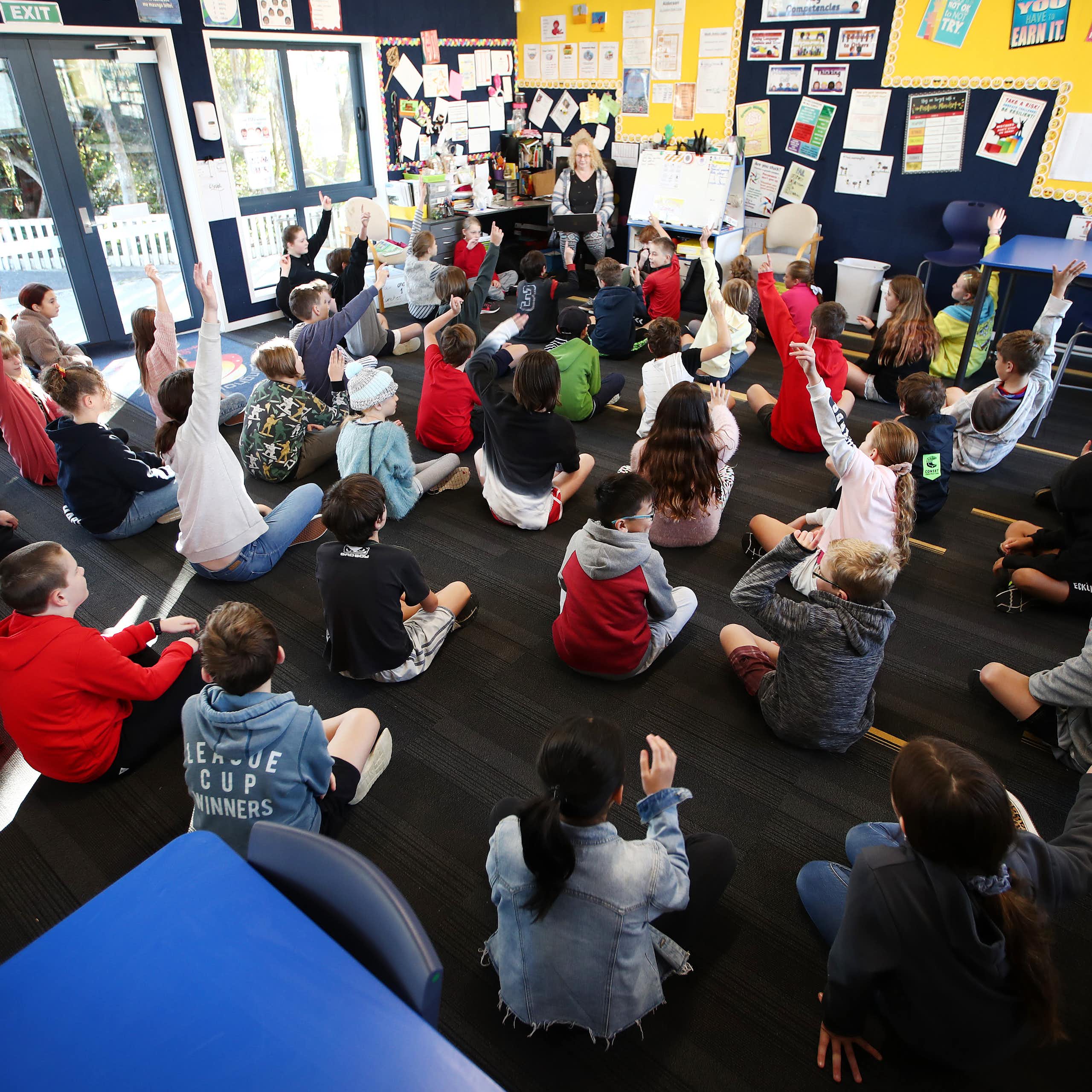 Teacher giving a lesson to a classroom of students
