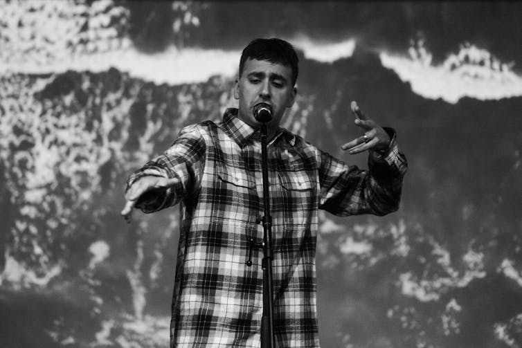 Black and white photo, a man on stage.