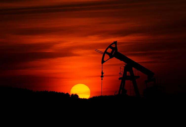 oil pump jack at sunset.