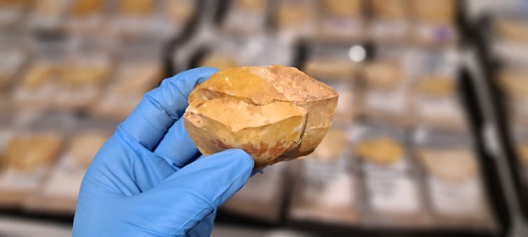 Two Aboriginal stone tools fitted together by hand.