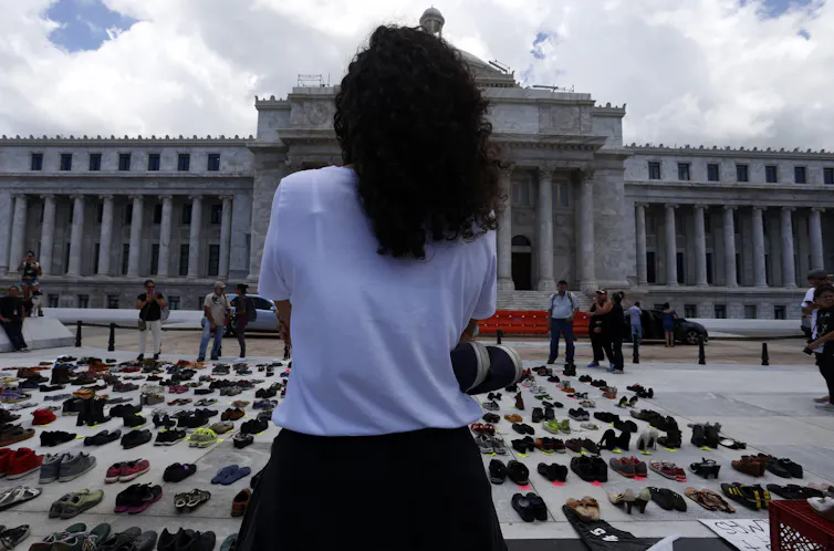 Pairs of shoes in front of Puerto Rico's capital building in San Juan. Each pair of shoes represents a person killed by Hurricane Maria