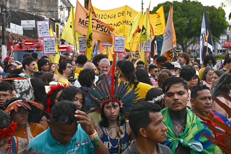 A group of protestors march along the street at the UN COP31 climate summit in Belem, Brazil.