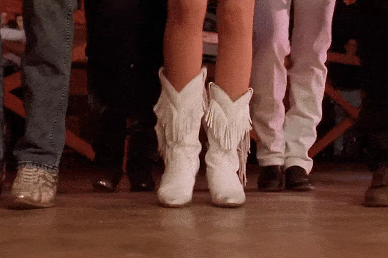 Close up feet of men and women country line dancing