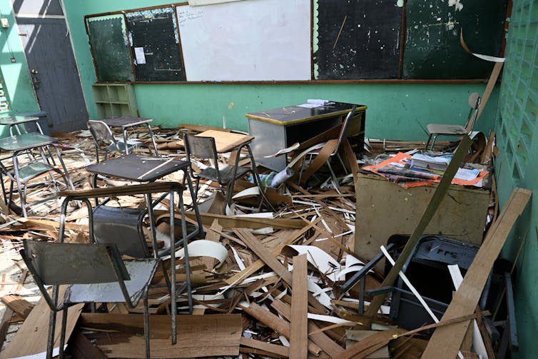 No time to get well: Typhoon Melissa and the Caribbean’s compounding crisis lure 1 The interior of a school that has been torn apart by hurricane winds. Desks and debris are scattered and light shines through the rafters