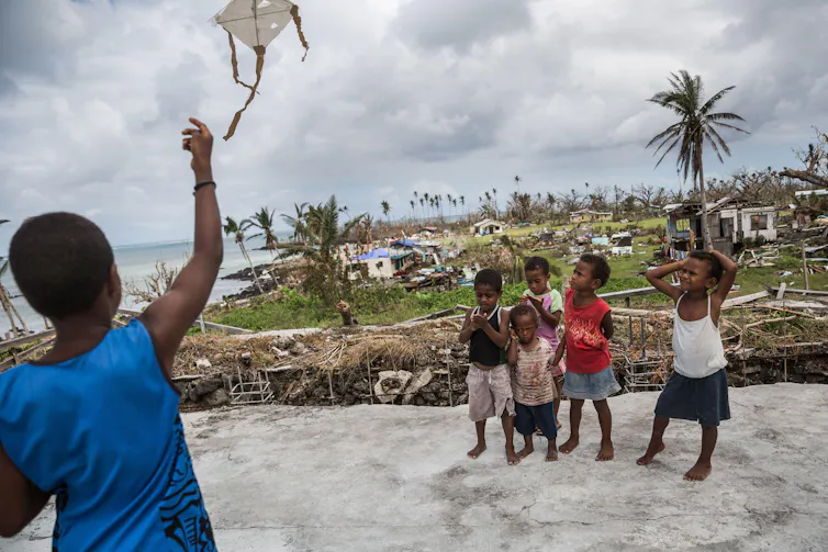 Children play in storm-damaged village