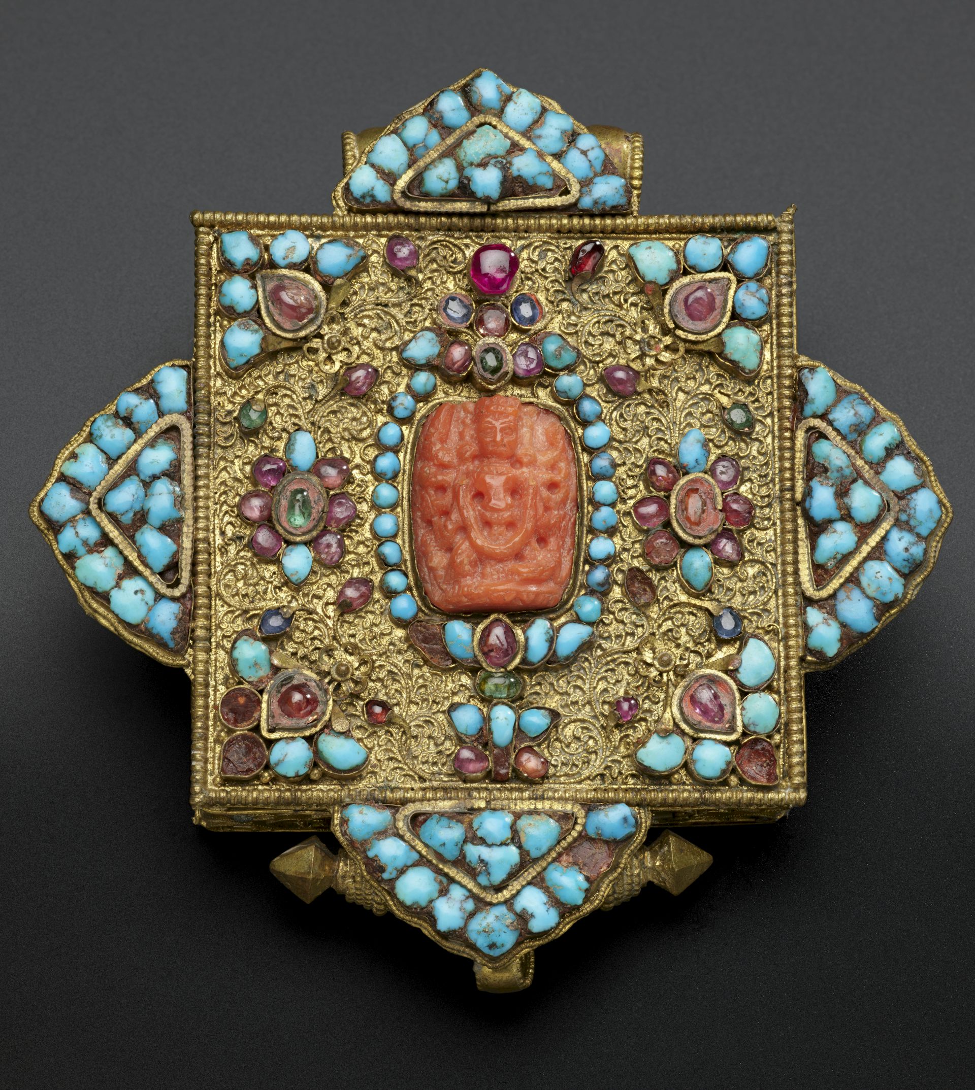 A Tibetan amulet decorated with turquoise.
