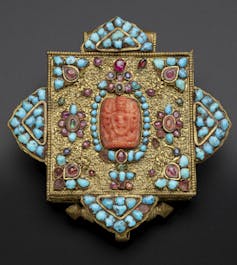 A Tibetan amulet decorated with turquoise.