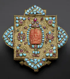 A Tibetan amulet decorated with turquoise.