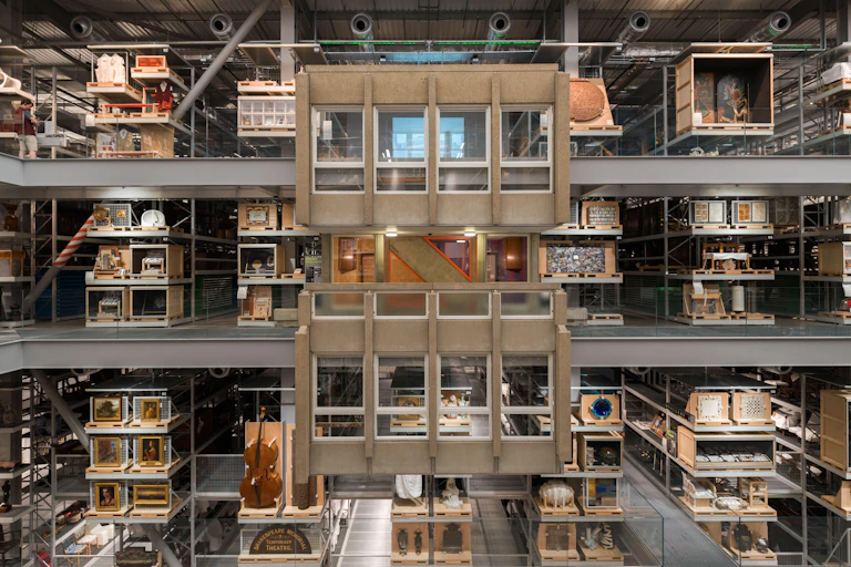 The inside of a museum storage collection showing three floors like a doll's house with the front removed.