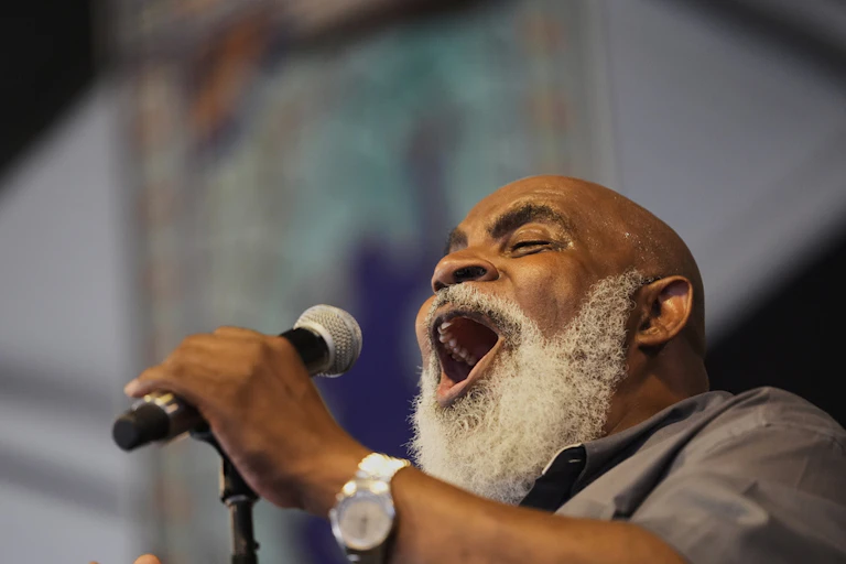 A man sings in a microphone.