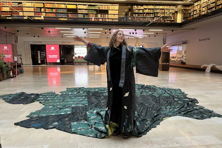 Person wearing a long green tapestry robe