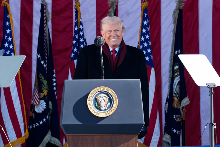 Trump speaking at a US podium