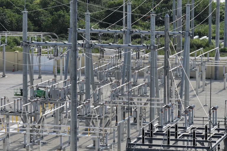 Wires, towers and equipment meet in a power-grid substation.