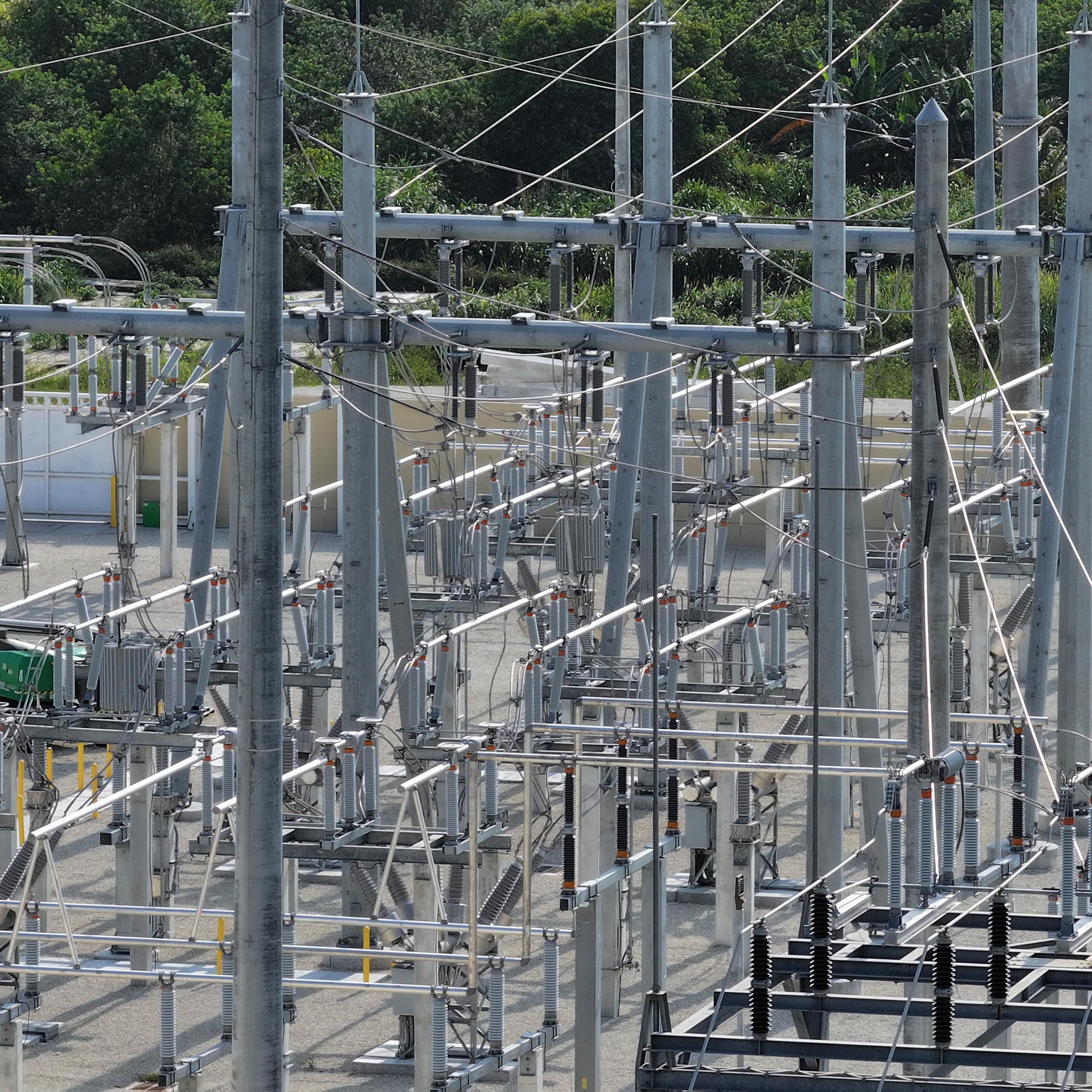 Wires, towers and equipment meet in a power-grid substation.