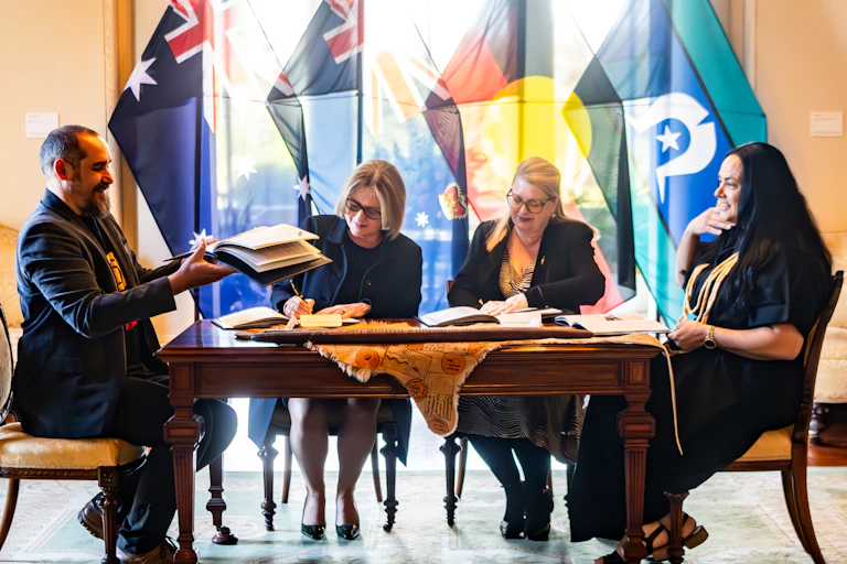 Victorian premier Jacinta Allan, Minister for Treaty Natalie Hutchins and First Peoples Assembly Co-Chairs Ngarra Murray and Rueben Berg sign the treaty.