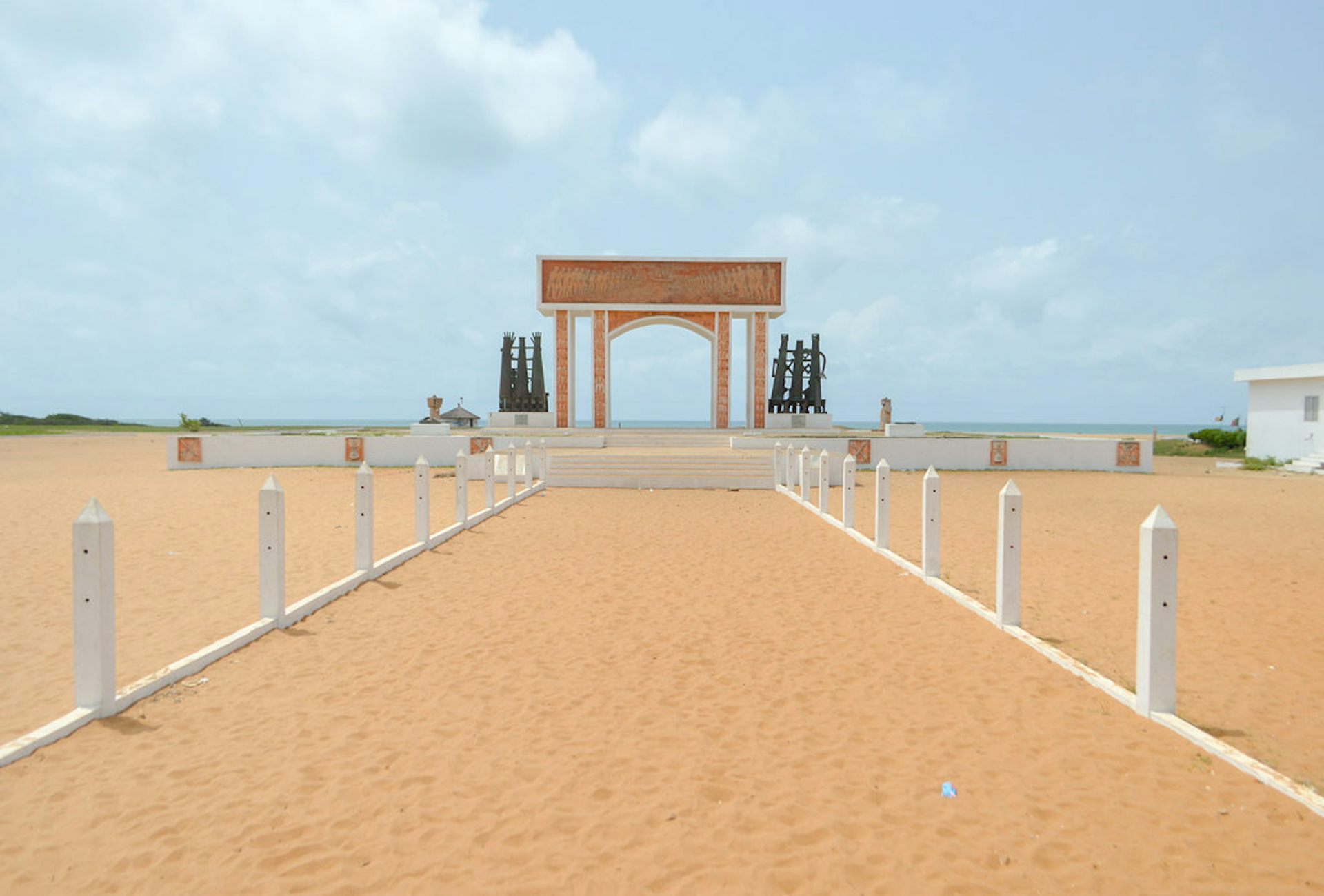 A sandy path leading to an arch