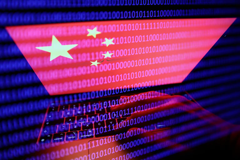 Flag of China displayed on a laptop screen and binary code displayed on a screen