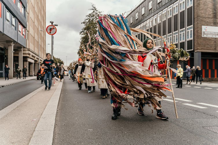 What do bushes take note? Our analysis unearths trauma and hope hidden of their recollections 7 Women carry a silver birch tree through a city street.