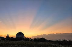 A planetarium seen against the setting sun